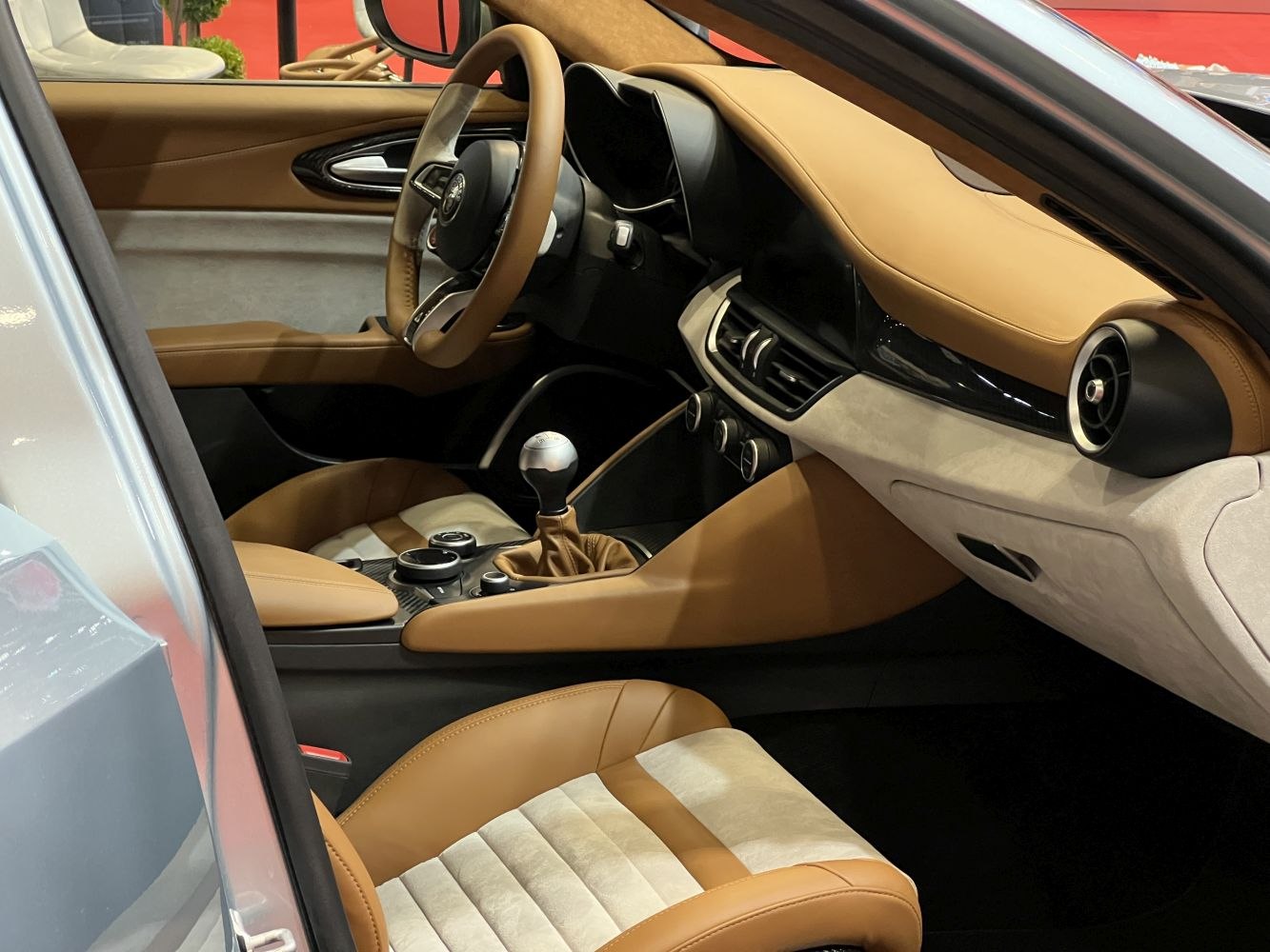 Tan and beige upholstery, manual gear shift, detailed dashboard