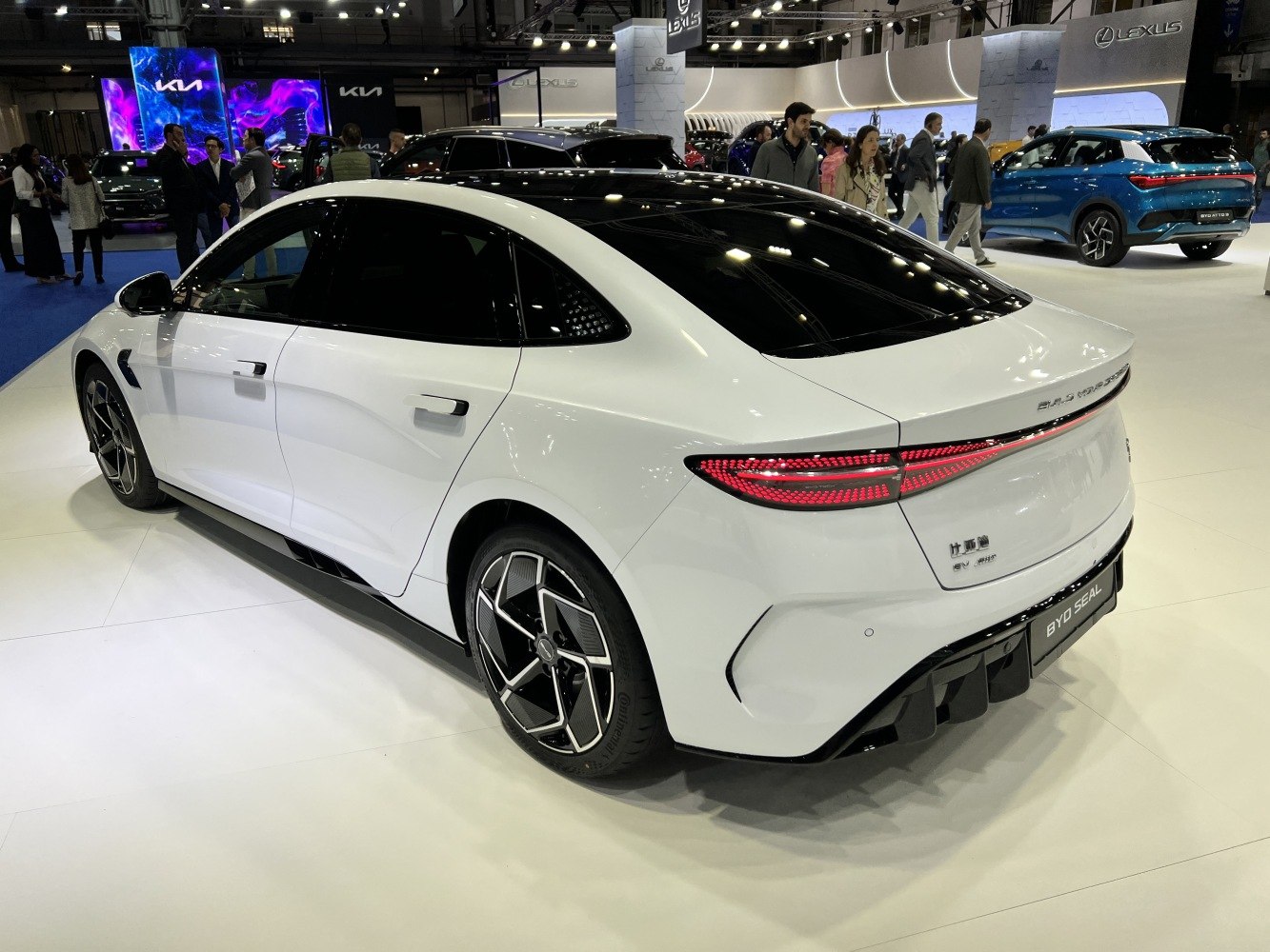 Rear view of electric sedan with continuous LED taillight and aerodynamic wheels