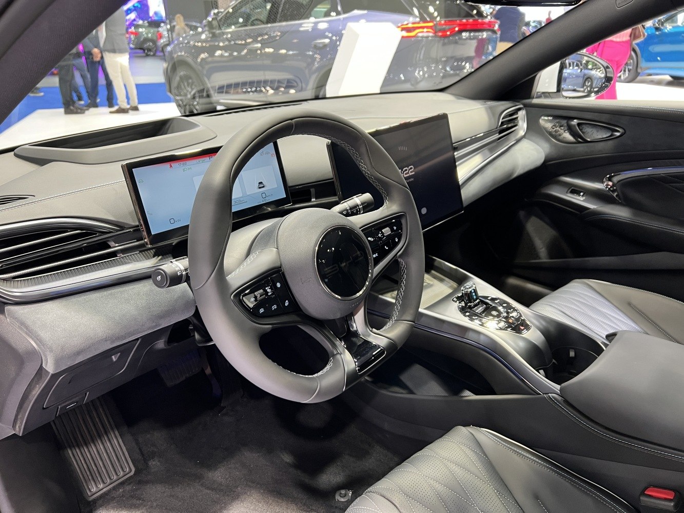 Advanced steering wheel with dual digital display screens inside a modern car interior
