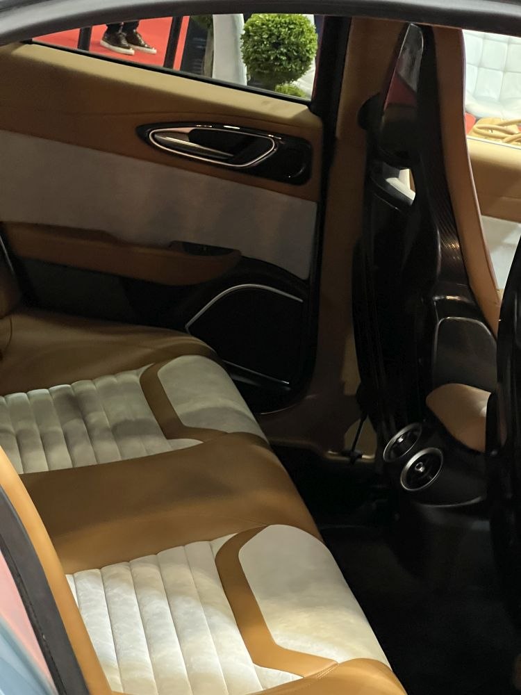 Two-tone leather upholstery and classic door handle in car interior