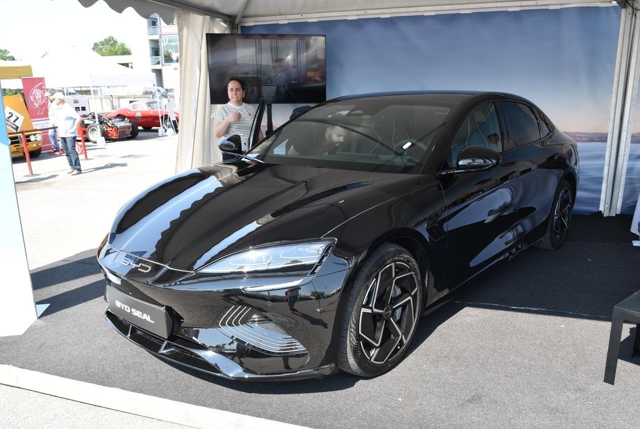 Sleek black electric sedan with LED headlights and aerodynamic design
