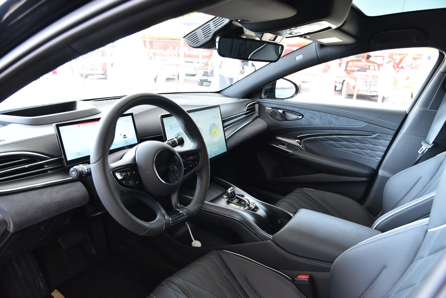 Modern digital displays and quilted leather seats in sleek car interior