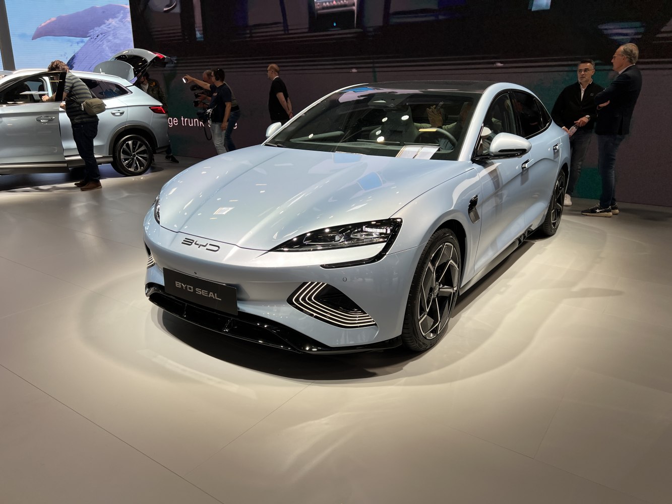 Front view of a sleek electric sedan with modern LED headlights and aerodynamic styling.