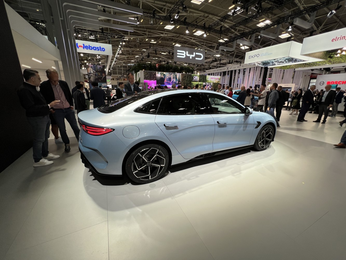 Side and rear view of electric sedan with aerodynamic shape and distinctive taillights