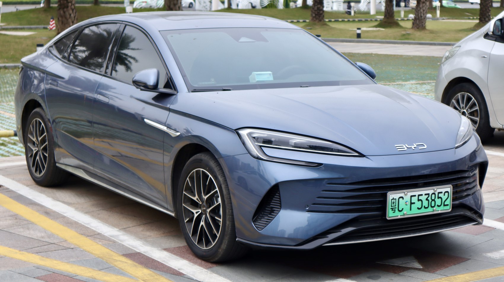Front and side view of sleek electric sedan with LED headlights and aerodynamic design
