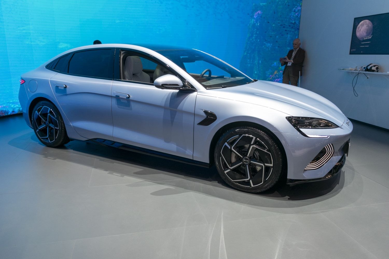 Futuristic electric sedan with aerodynamic body and distinctive wheel design