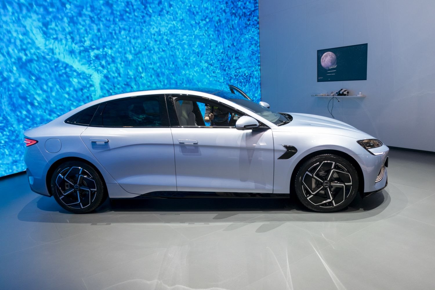 Sleek electric sedan side profile with modern alloy wheels