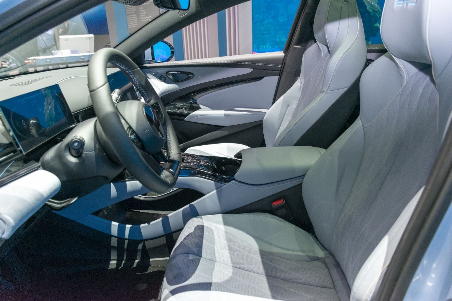 Modern car interior with steering wheel and front seats