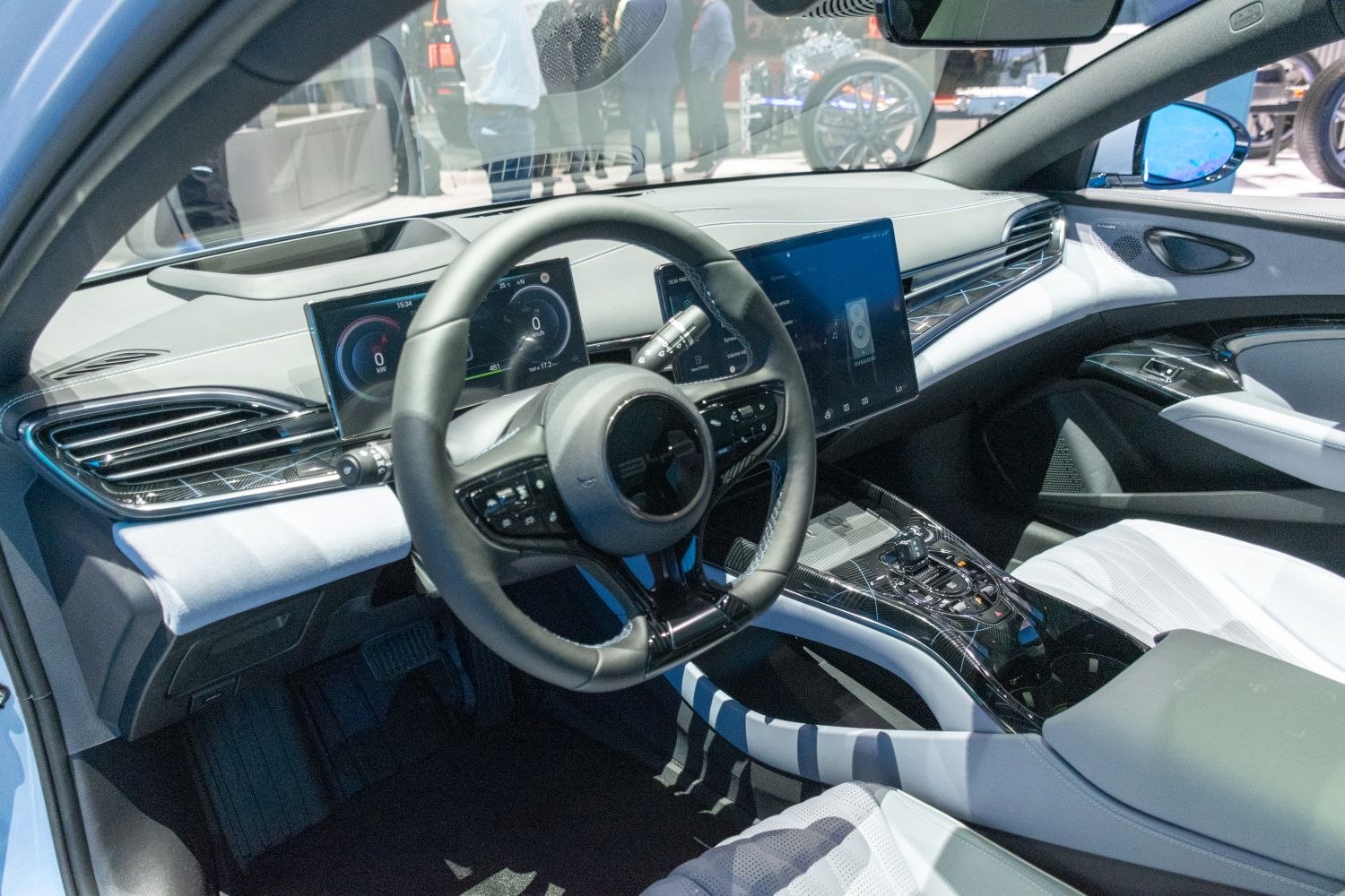 Dual digital displays and modern steering wheel in car interior