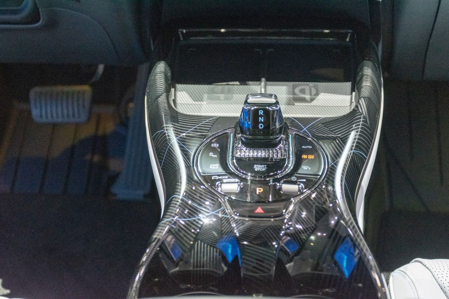 Sleek gear shift console with illuminated controls and start/stop button