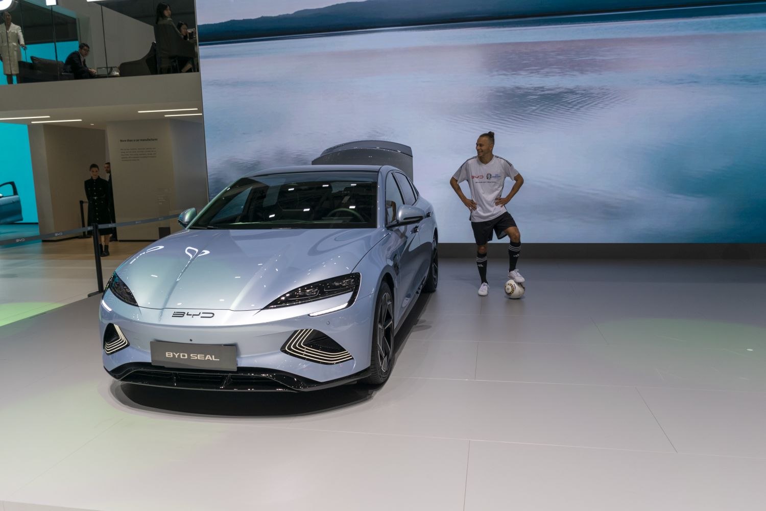 Sleek electric sedan front with distinctive headlights and aerodynamic styling