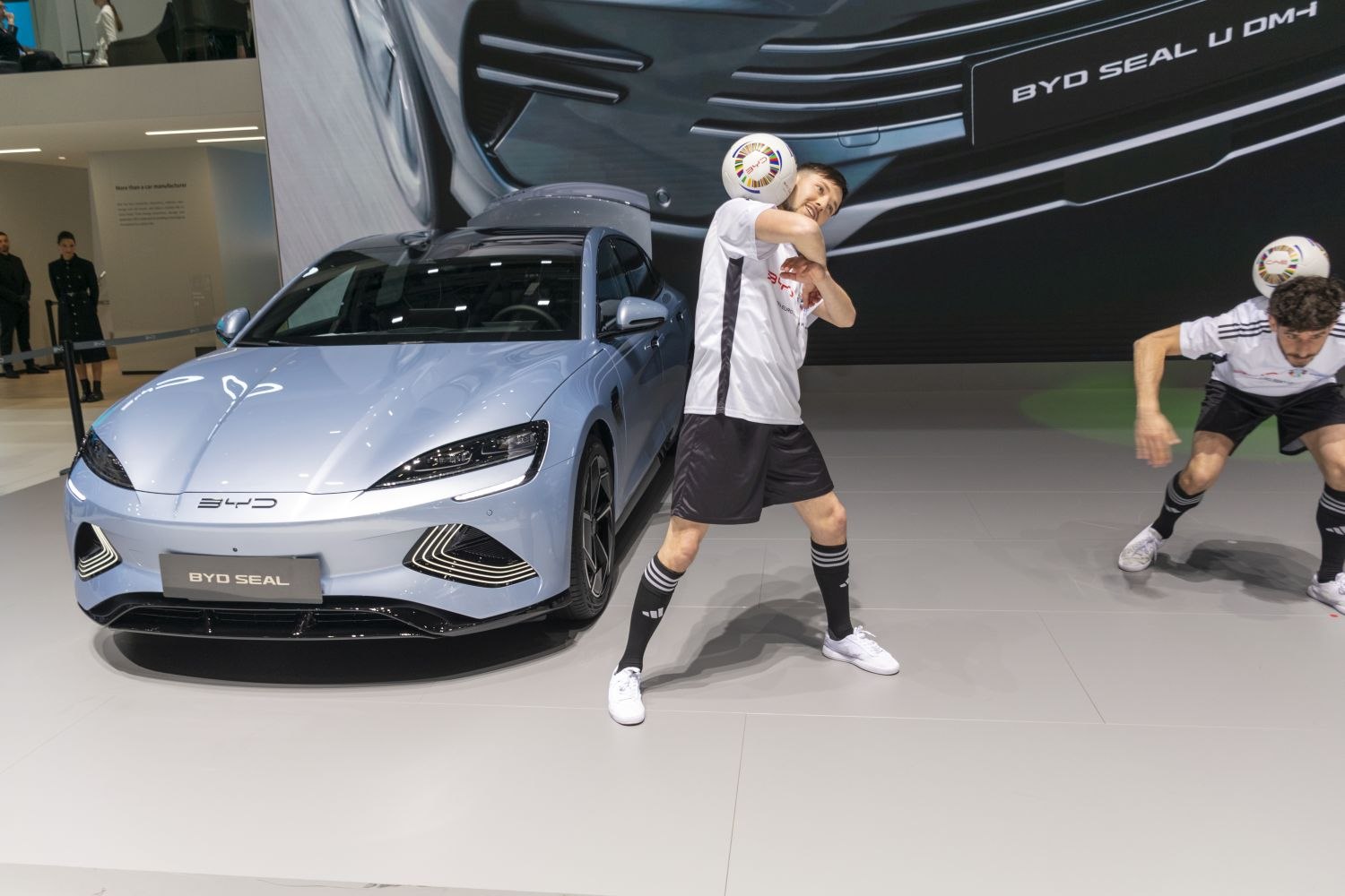 Front view of electric sedan with sleek headlights and sporty bumper