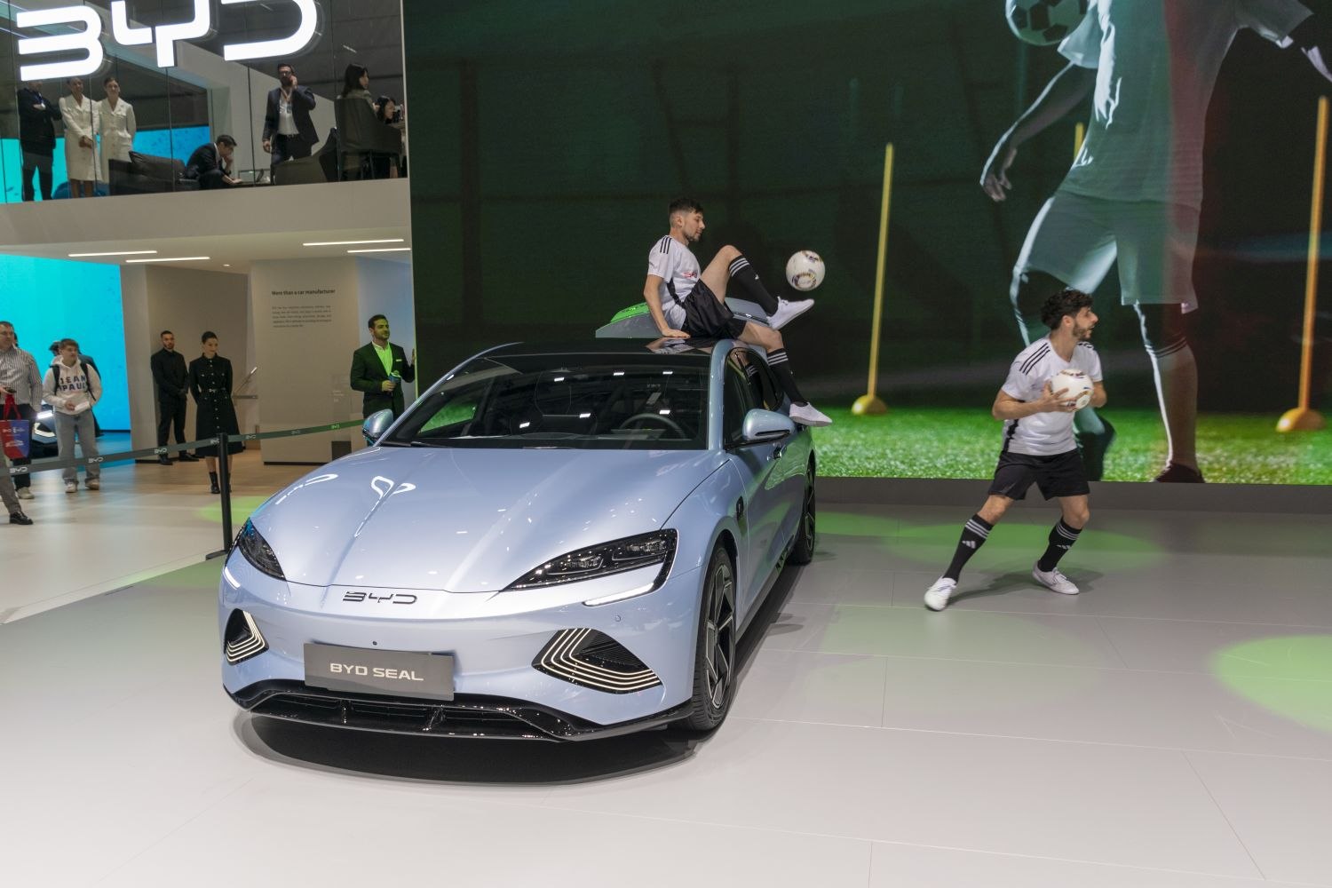 Electric sedan with soccer-themed live performance at auto show