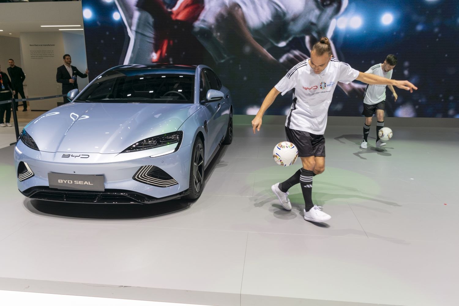 Modern electric sedan front view with sleek headlights and sporty grille