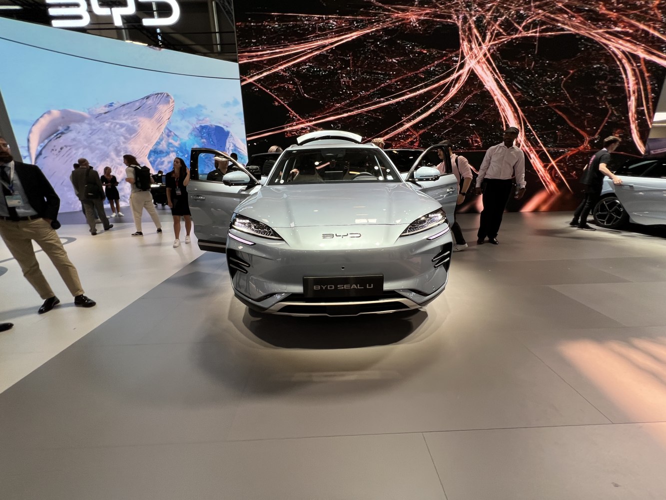 Front view of modern electric vehicle with open front doors