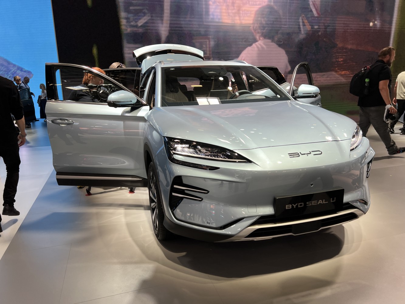 Front view of electric SUV with LED headlights and open doors