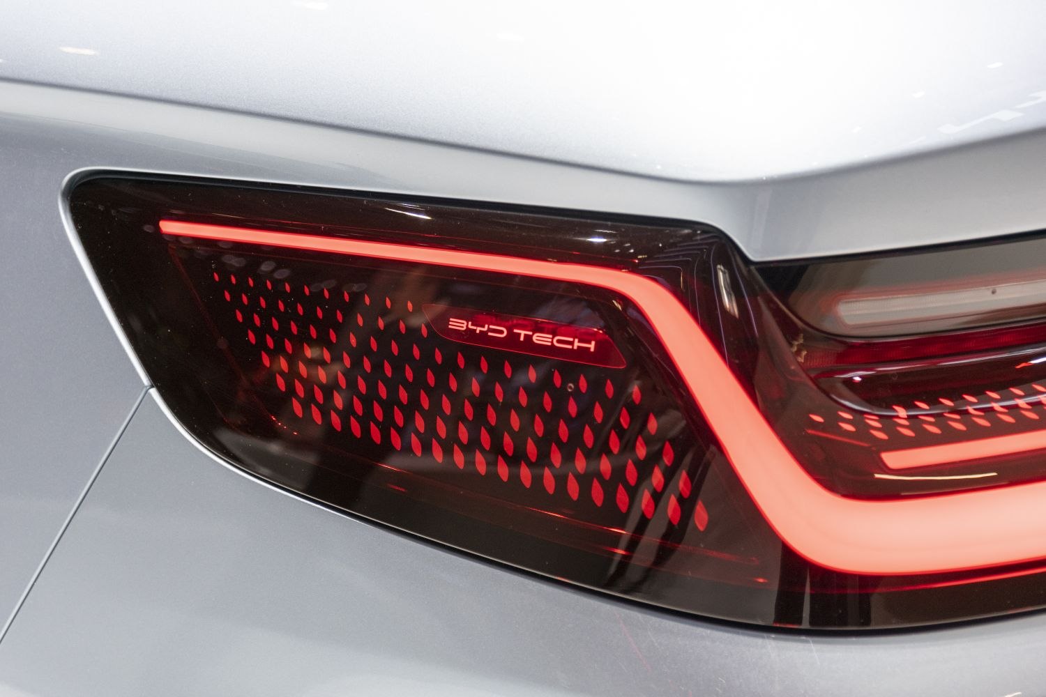 Close-up of unique rear taillight with BYD Tech emblem and intricate red LED pattern.