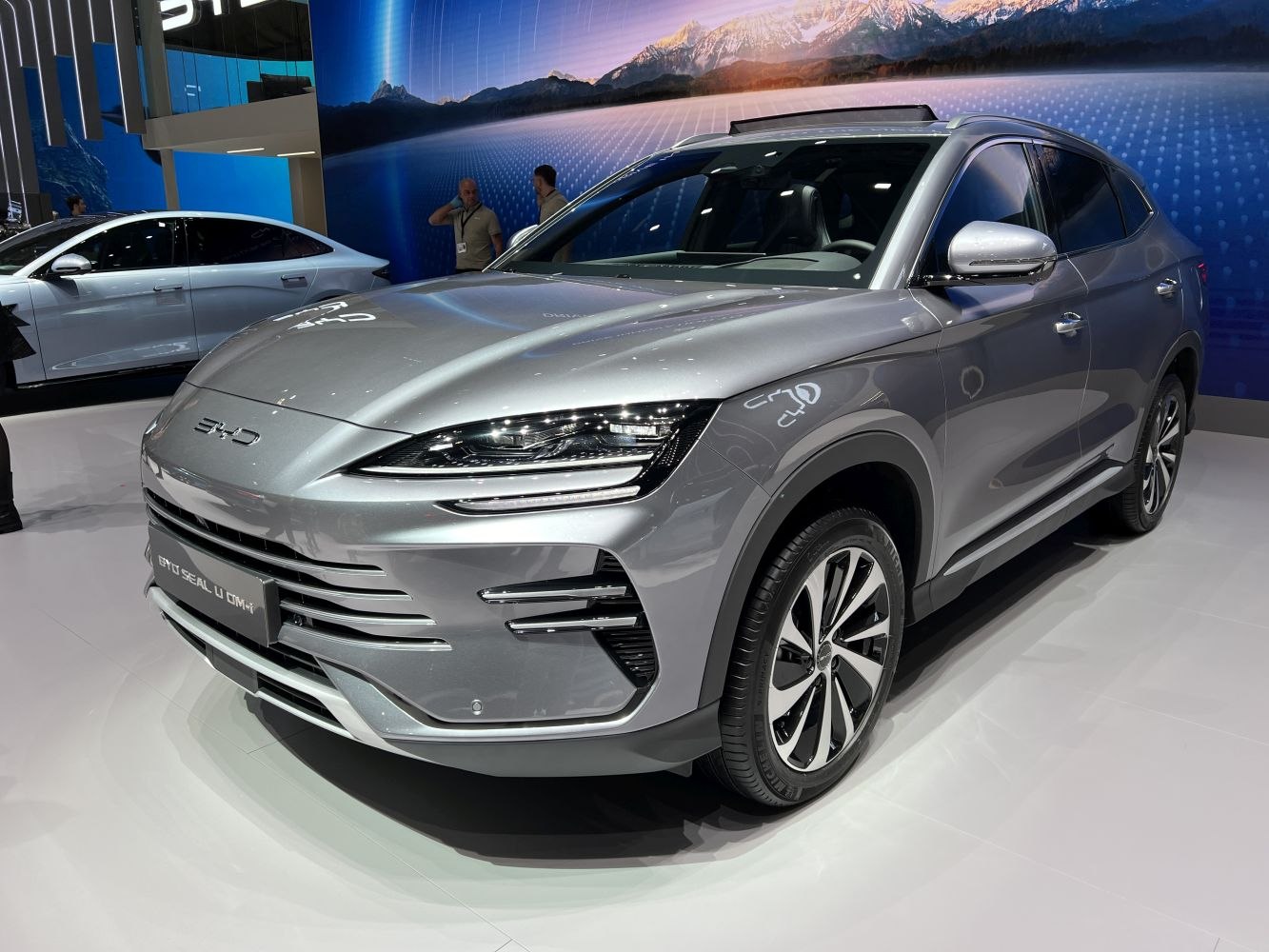 Front three-quarter view of a silver electric SUV with sleek LED headlights.