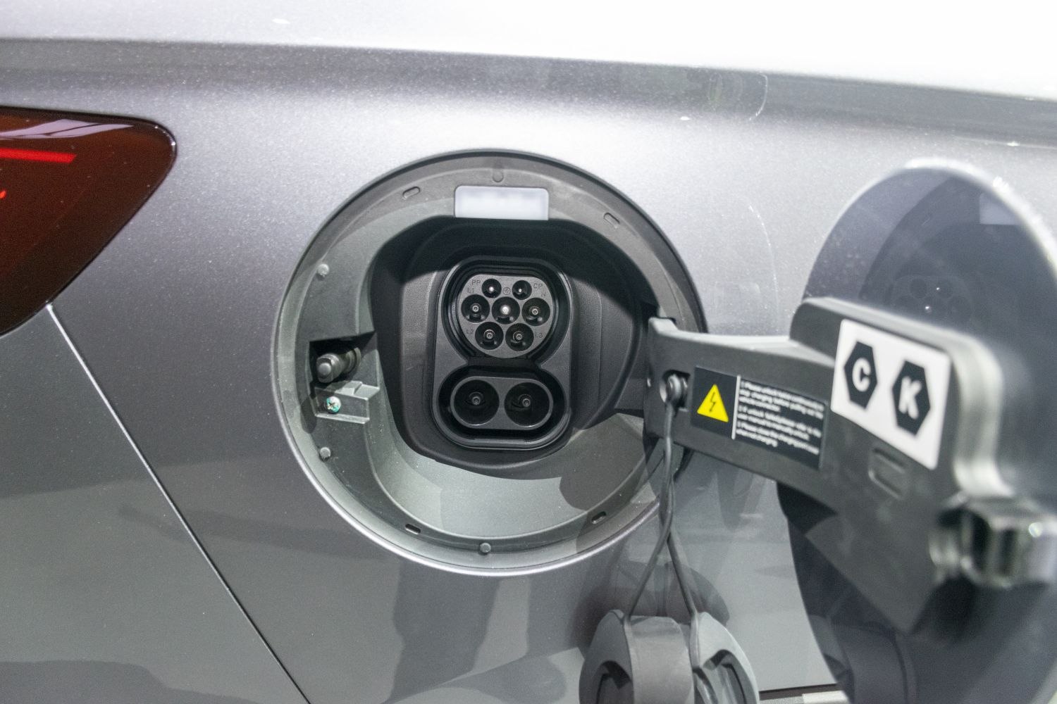 Close-up of electric vehicle charging port with advanced plug interface