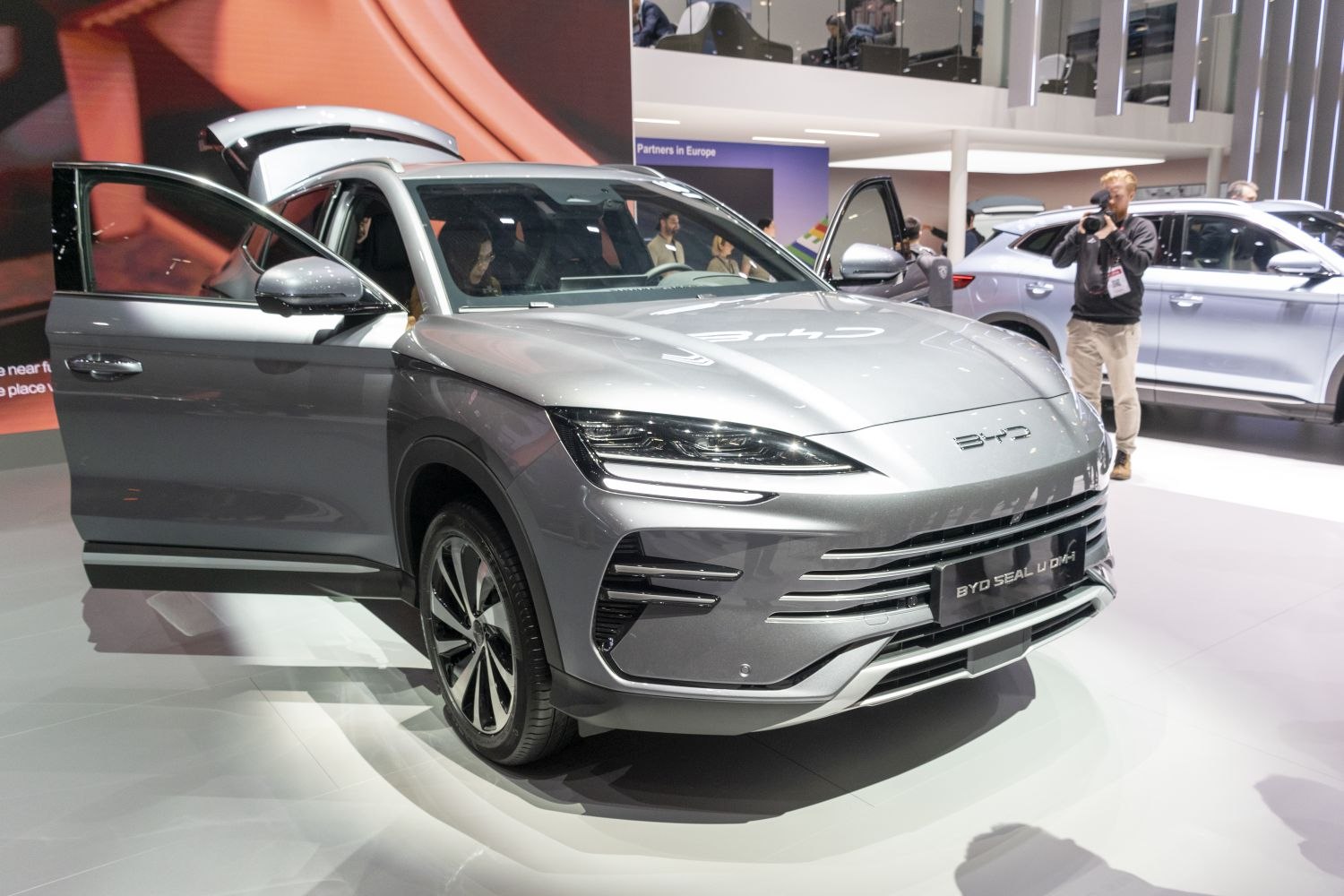 Front view with open doors and sleek LED headlights