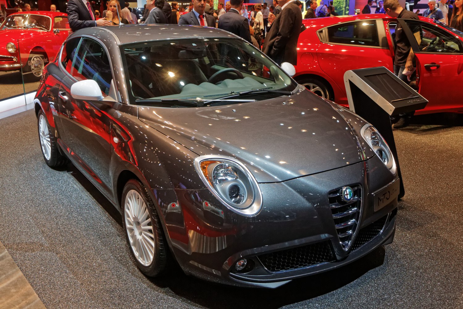 Front view with round headlights and sporty grille in metallic gray finish