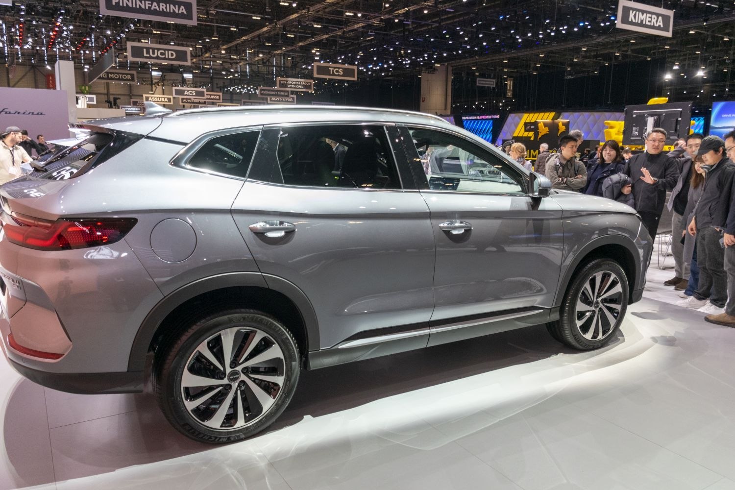 Side profile of electric SUV with alloy wheels at exhibition