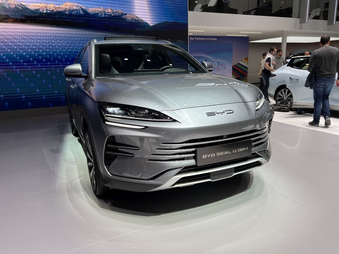 Front of modern SUV with sharp LED headlights and horizontal grille