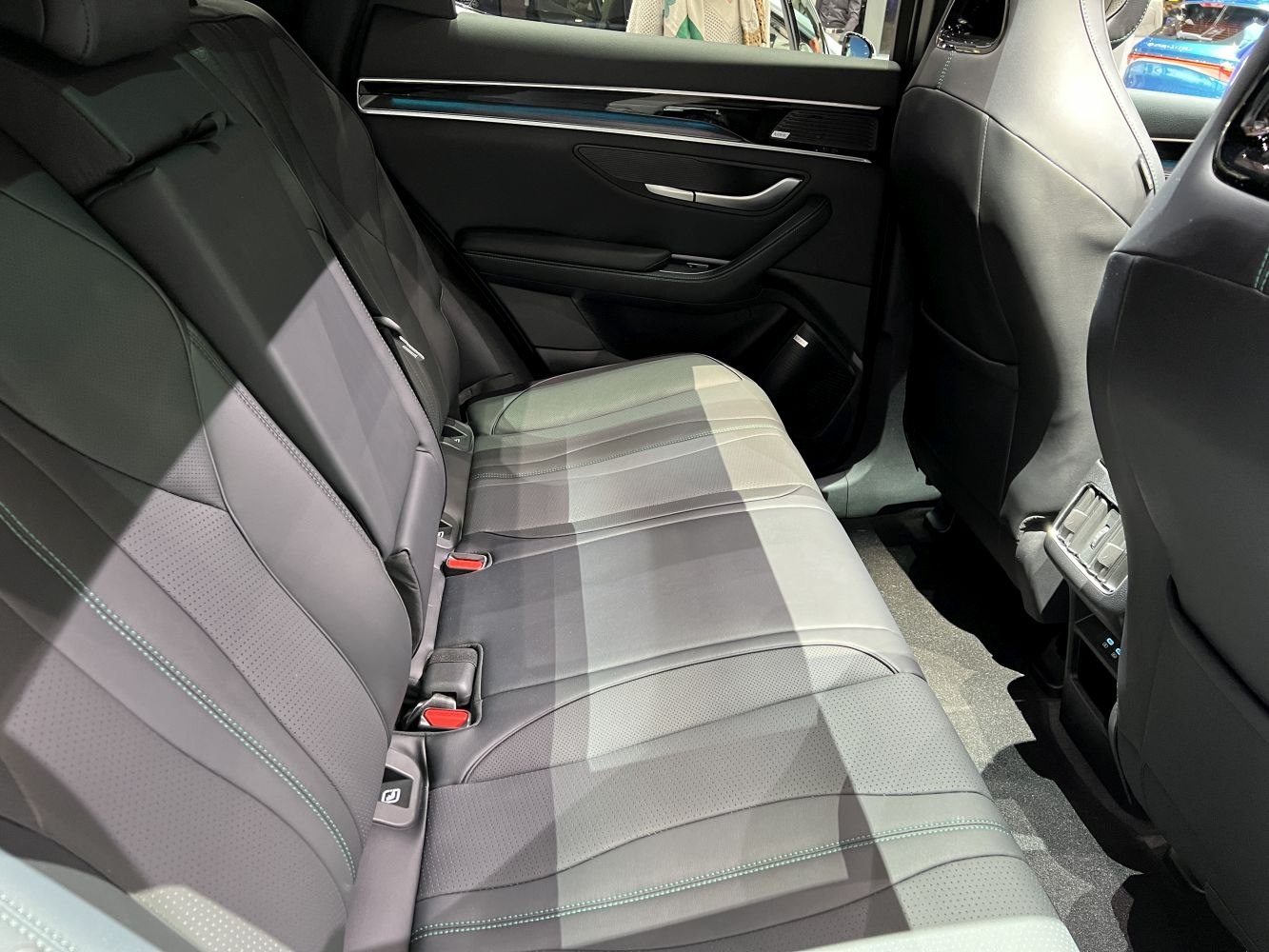 Rear seat with leather upholstery and modern door panel design
