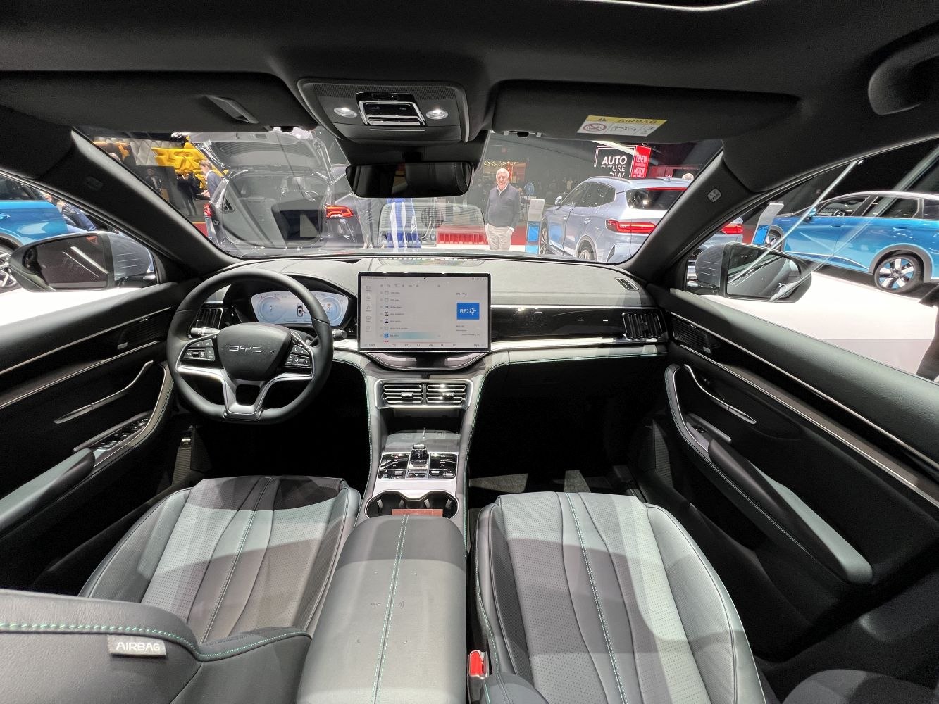 Modern interior with digital dashboard, touchscreen, and steering wheel controls