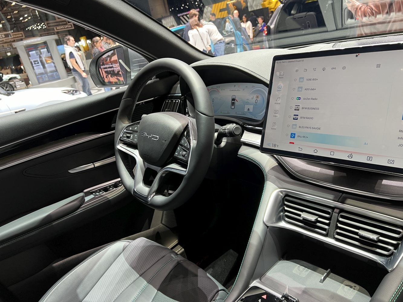 Modern steering wheel with digital dashboard and large touchscreen display