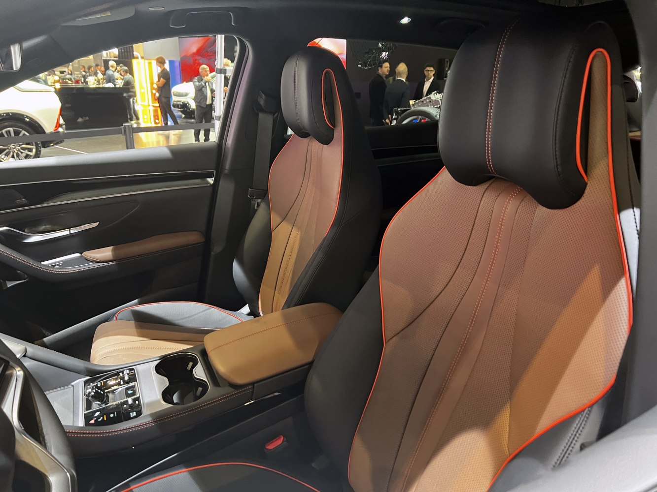 Brown leather sport seats with orange piping and modern center console