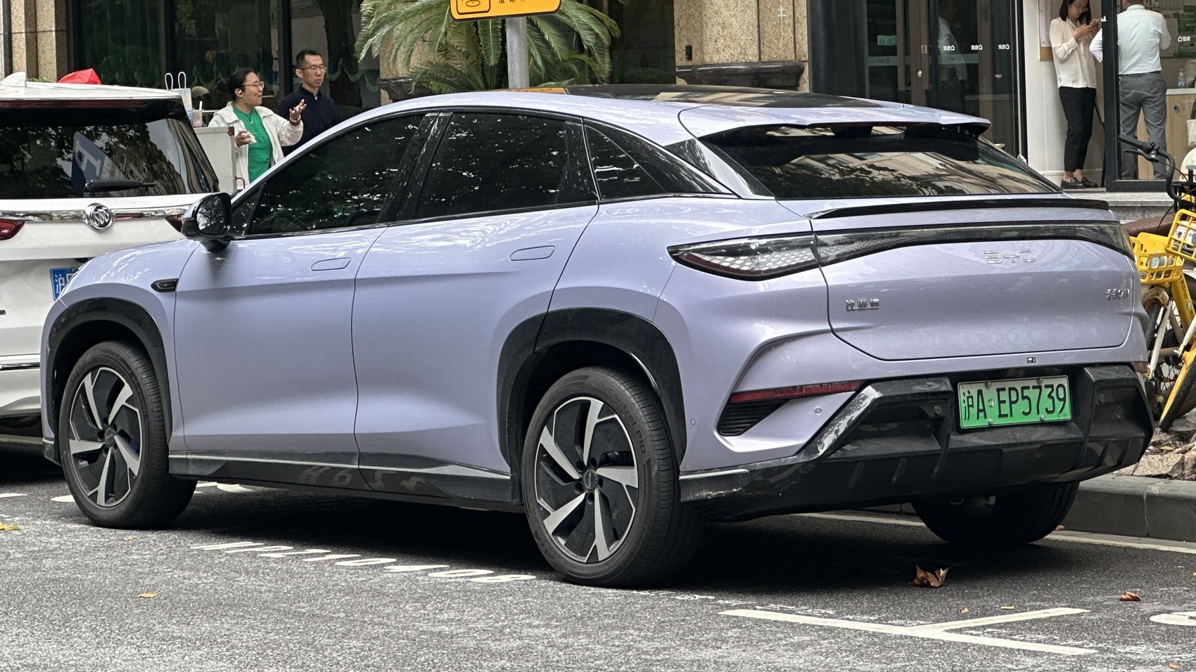Rear-side view of a modern electric SUV with aerodynamic design and tinted windows