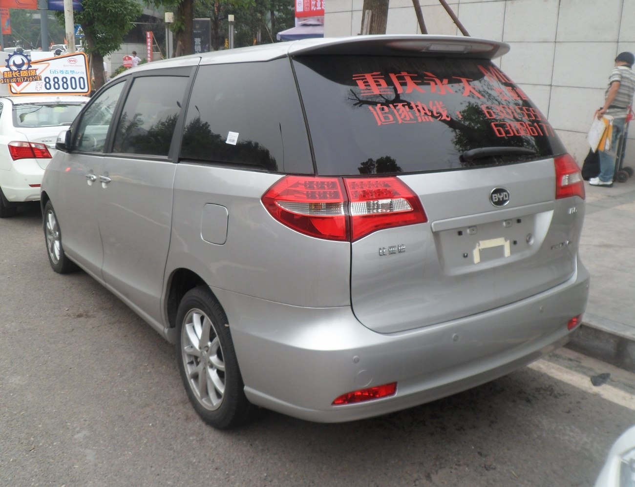 Silver minivan rear view with tinted windows and distinctive taillights