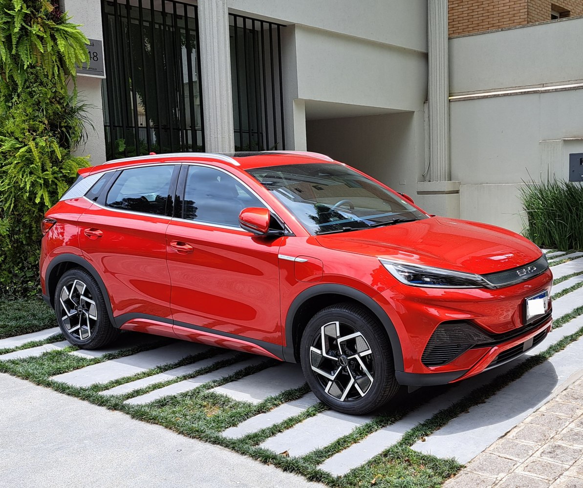 Sleek red electric SUV front side with LED headlights and aerodynamic design