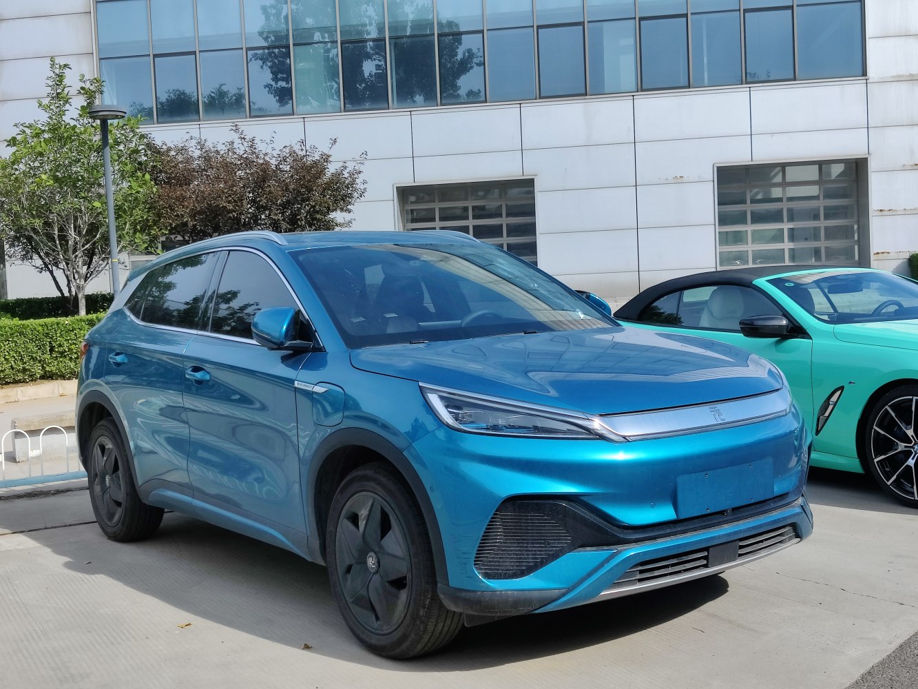 Front and side view of blue electric SUV with aerodynamic wheels