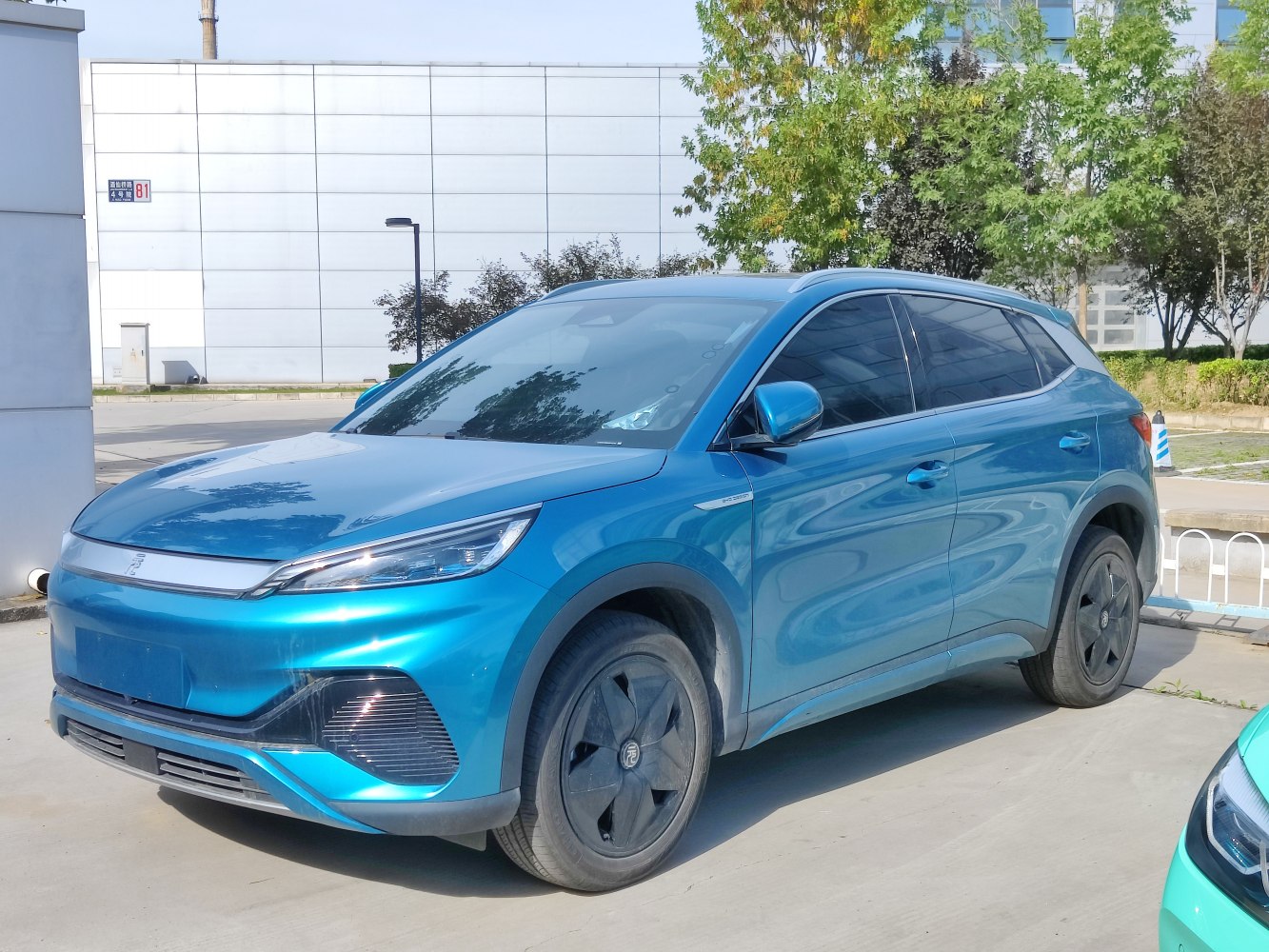 Blue electric SUV with sleek headlamps and tinted windows