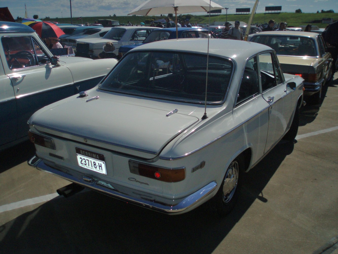 rear view of classic sedan with chrome bumper and dual antennas