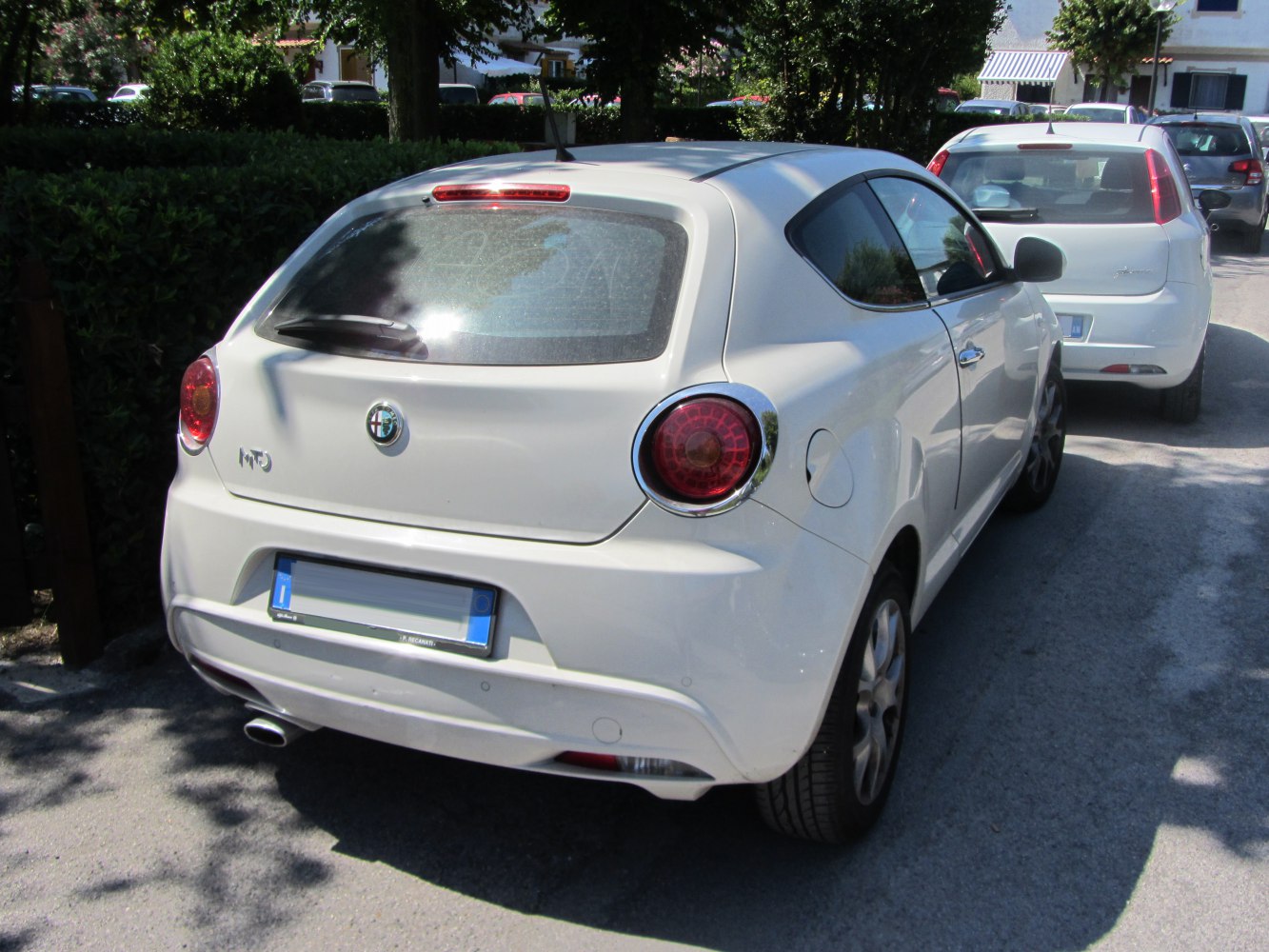 Compact hatchback rear with round taillights and single exhaust pipe