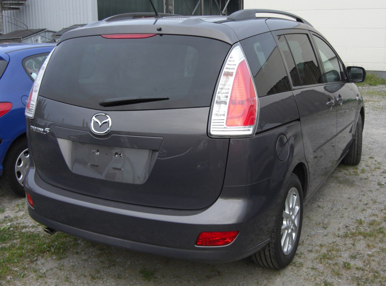 Tall tail lights and rear window with wiper on compact minivan rear.