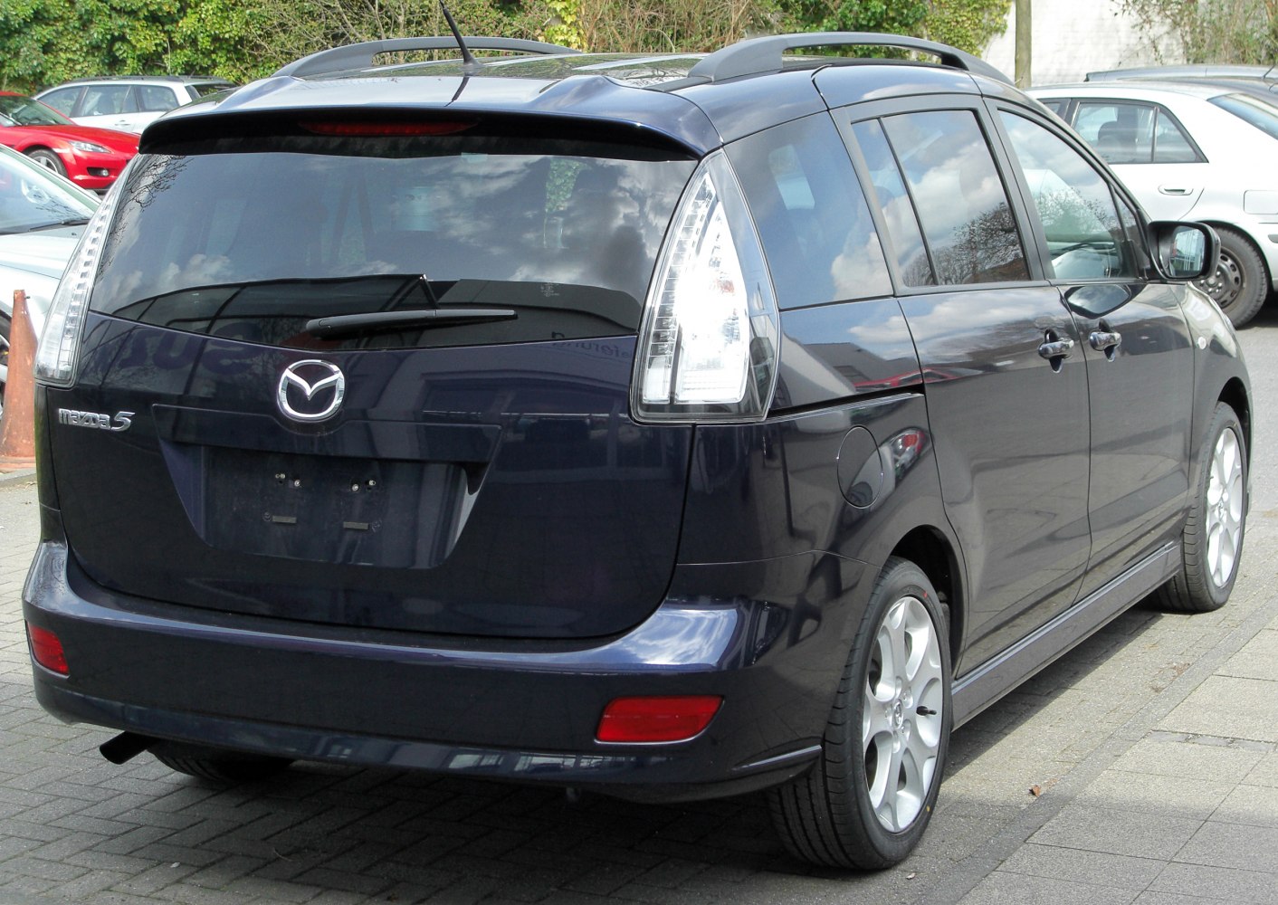 Rear view of compact minivan with vertical taillights and rear wiper