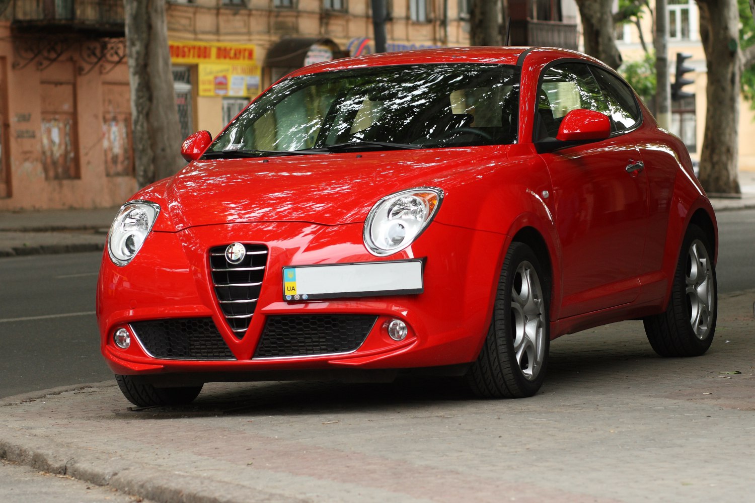 Compact sporty hatchback front view with distinctive grille and rounded headlights