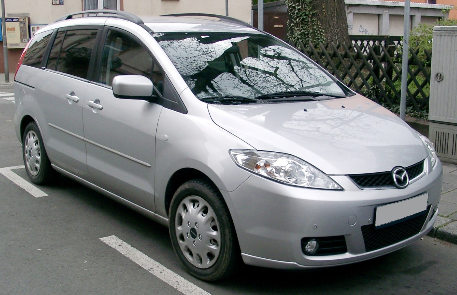 Silver minivan front side view with sliding doors and alloy-style wheels