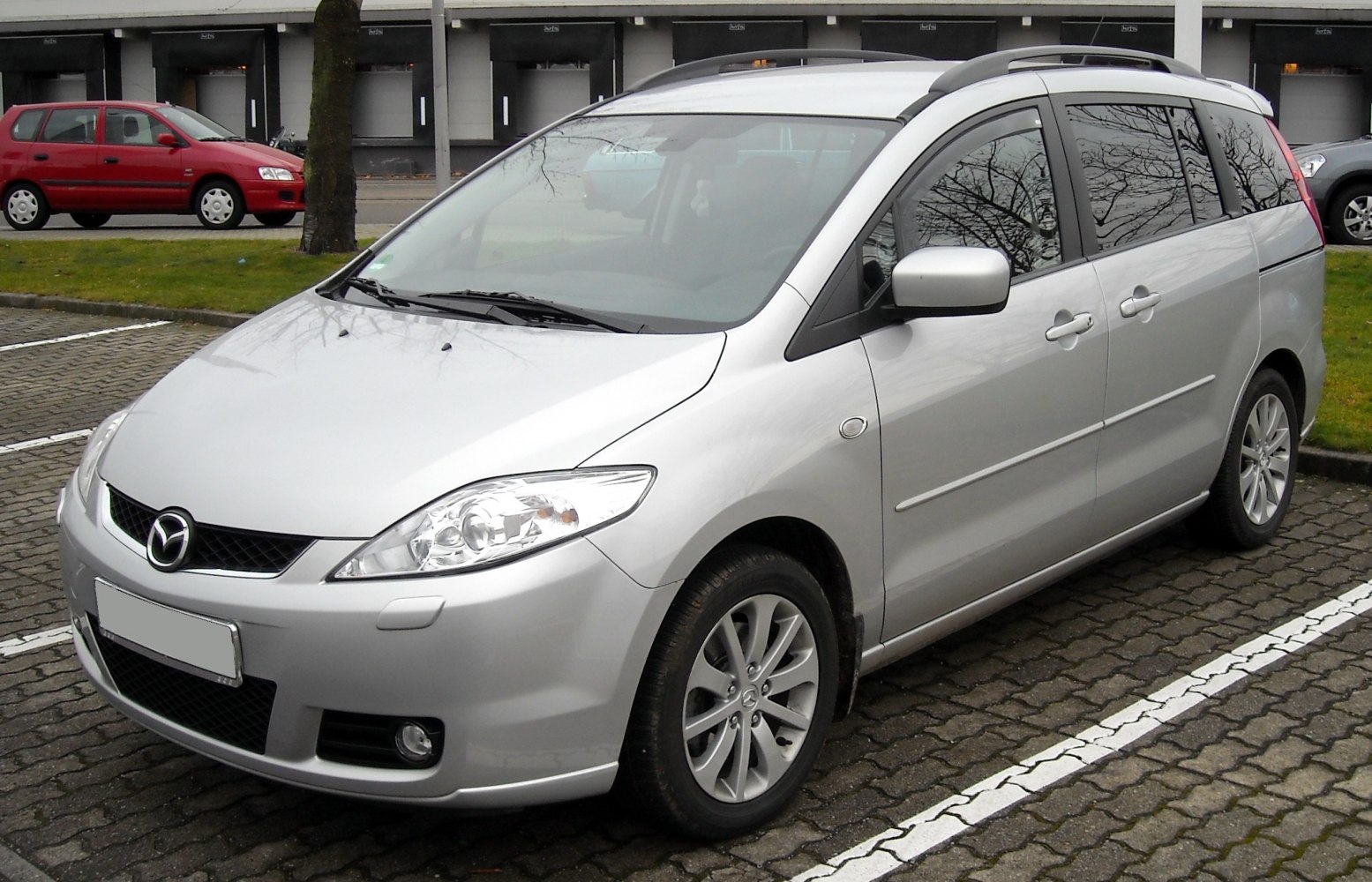 Silver compact MPV front and side view with alloy wheels and roof rails