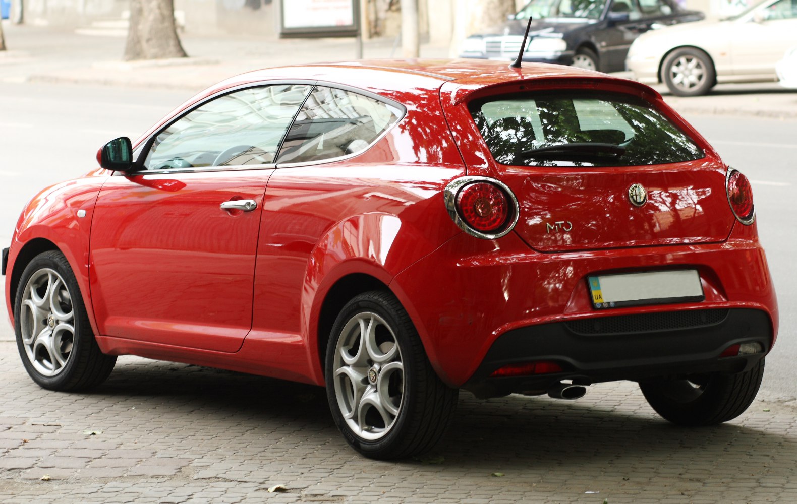 Rear hatchback view with round taillights and sporty alloy wheels
