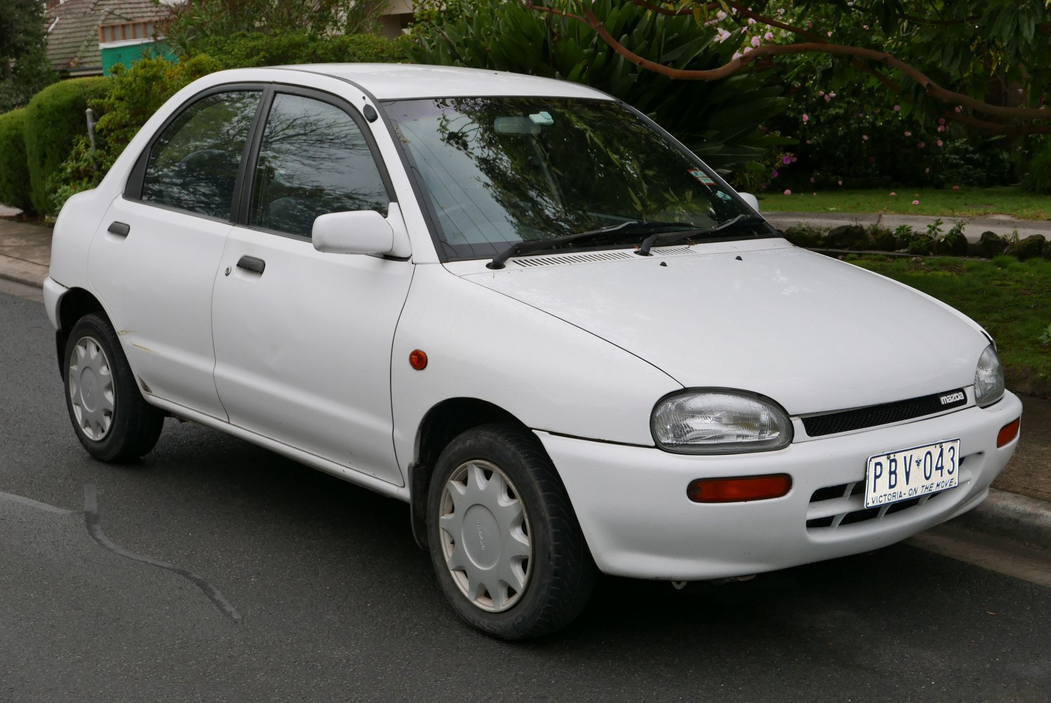 Compact white hatchback with rounded headlights and smooth body