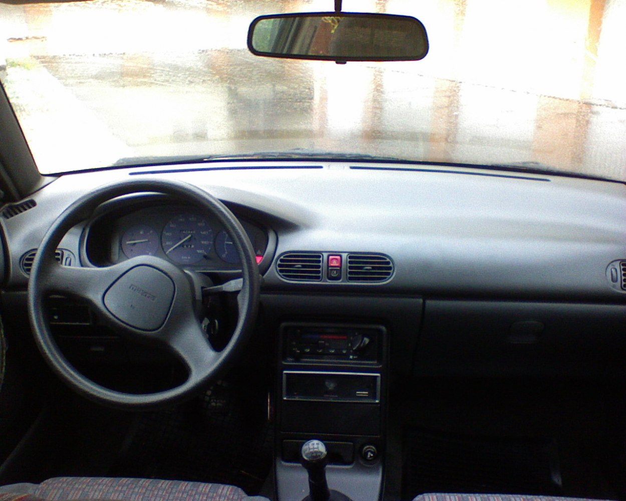 Dashboard, steering wheel, and manual gear shifter from car interior
