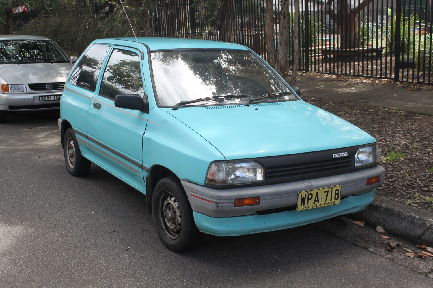 Light blue compact hatchback with rectangular headlights and simple late 80s design