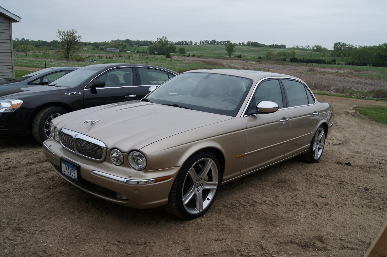 Luxury sedan with quad circular headlamps and silver alloy wheels