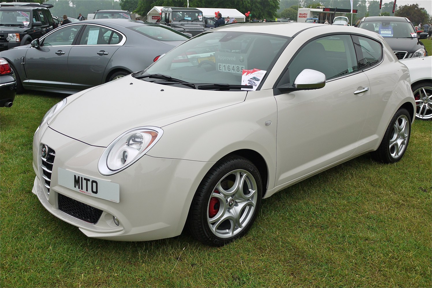 Compact hatchback with round headlights and sporty alloy wheels.