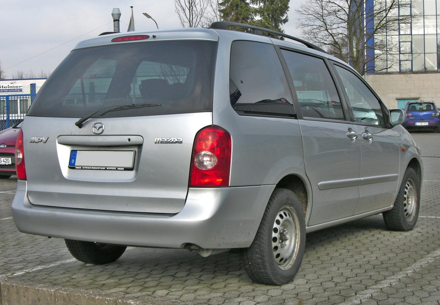 Silver minivan rear view with tailgate and taillights